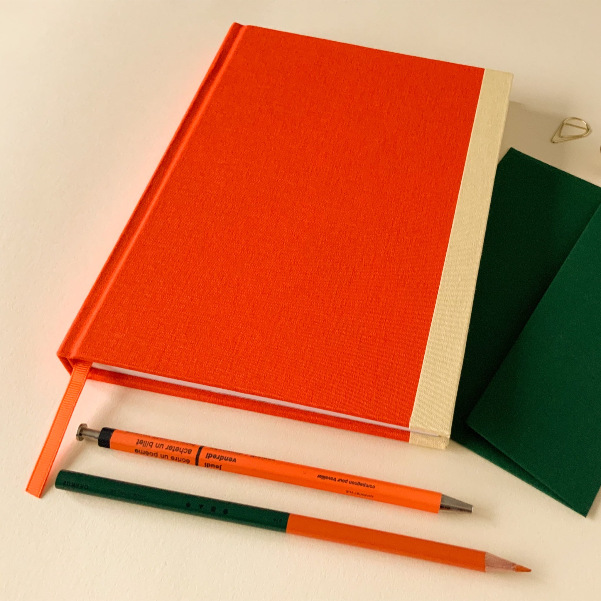 Orange fabric covered hardback sketchbook.
