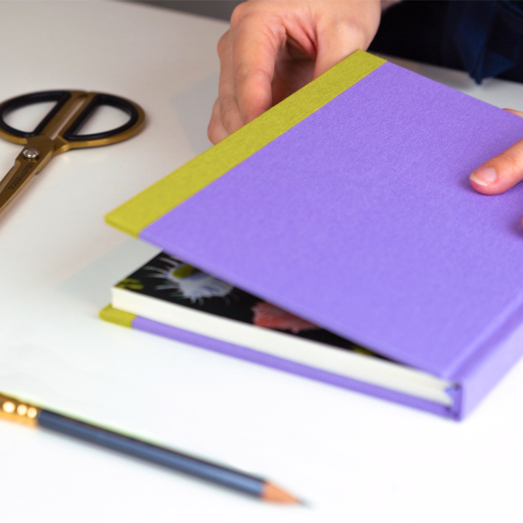 Lilac fabric covered hardback sketchbook.